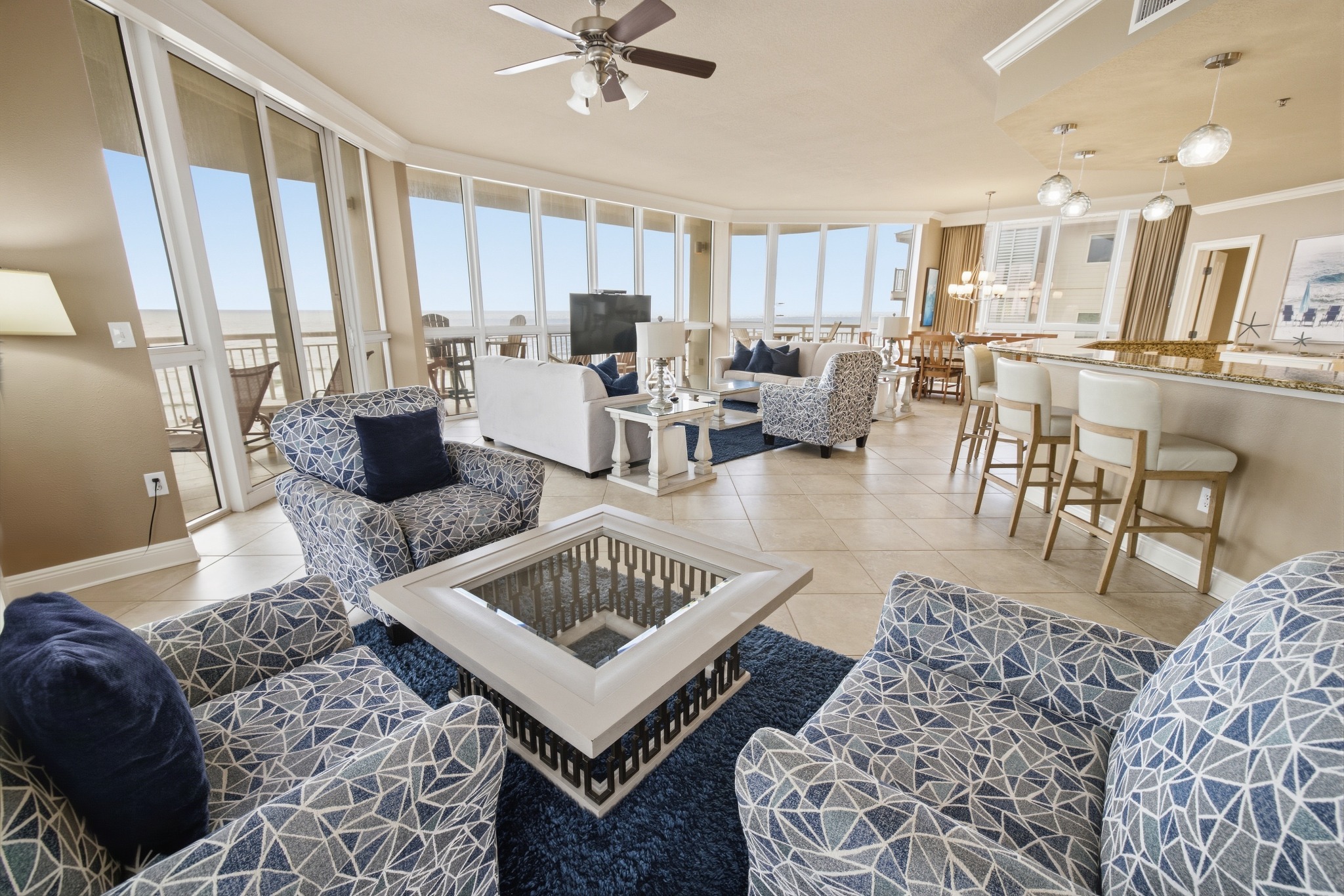 Open coastal condo living and dining spaces
