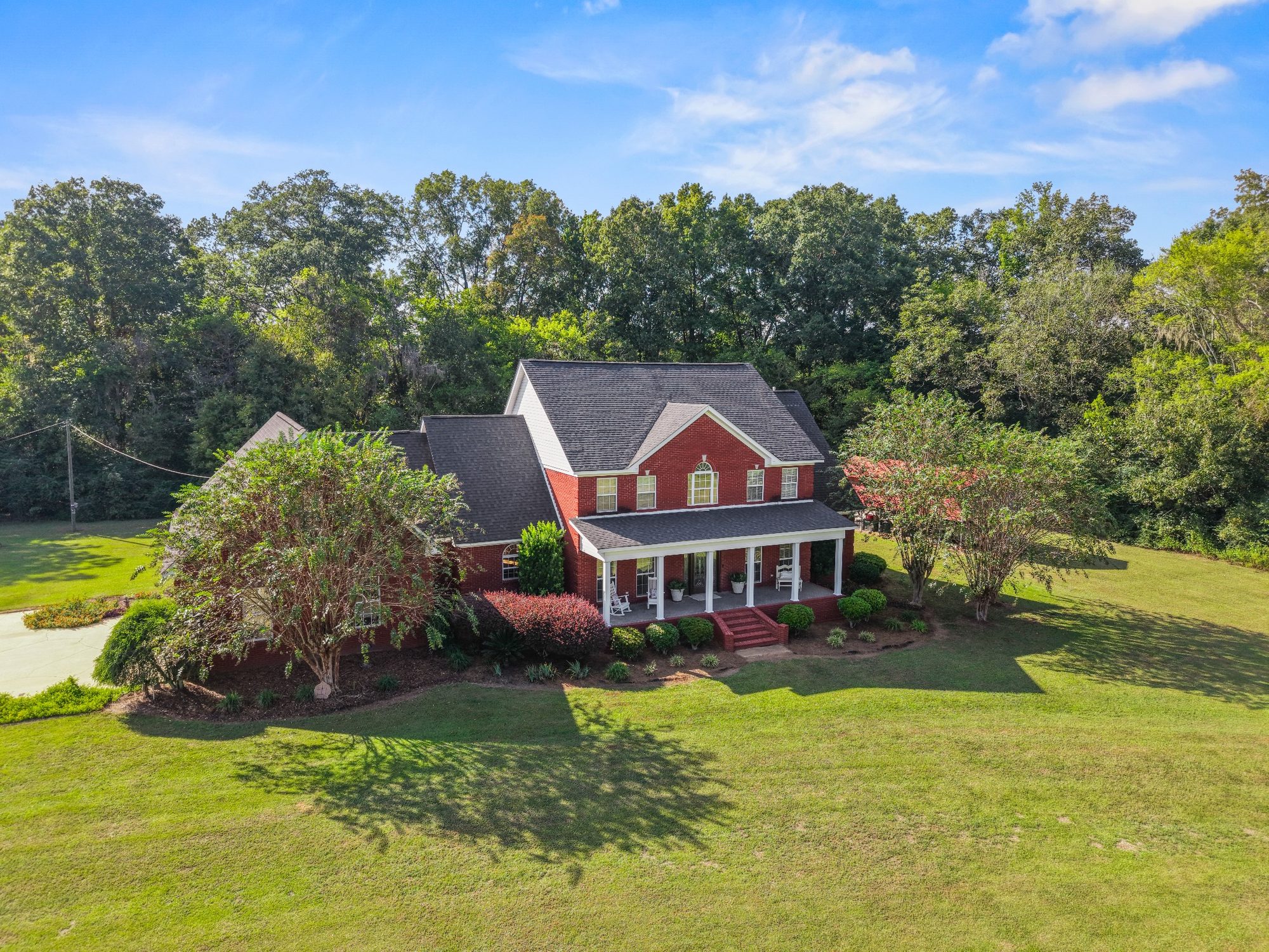 Aerial view of a brick home and garden